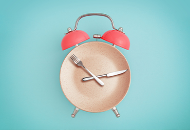 Fasting concept of plate and clock